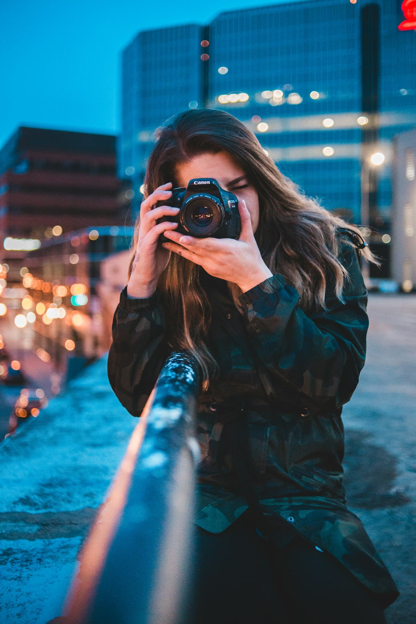 Creator shooting content with her camera in the city at dusk
